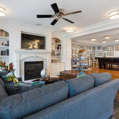 basement fireplace natural light ceiling fan TV over hearth